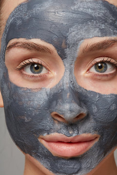 Stunning woman with clay mask treatment