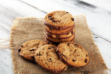 Chocolate cookies on wooden table. Chocolate chip cookies shot on wooden white table