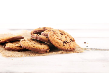 Chocolate cookies on wooden table. Chocolate chip cookies shot on wooden white table