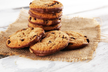 Chocolate cookies on wooden table. Chocolate chip cookies shot on wooden white table