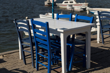 the table and chairs concept by the sea in the cafe from Aegean 