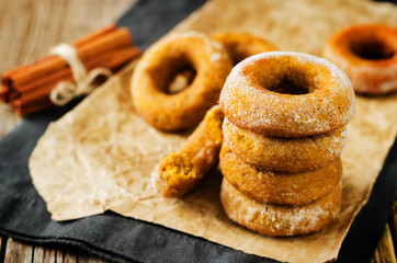 Baked pumpkin donuts with glasses of milk