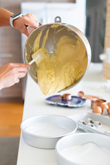 pouring vanilla batter into cake pan