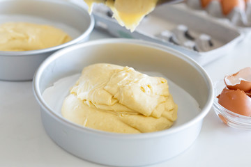 pouring vanilla batter into cake pan