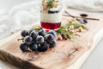 Vanilla Panna Cotta with a Concord Grape Gelee Topped with Whipped Chantilly Cream and Toasted Hazelnut and Served with a Slice of Hazelnut Biscotti