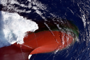 Bulbous bow of the cargo ship sailing through the ocean. 