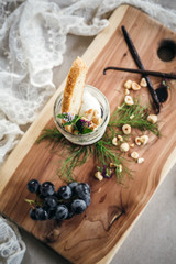 Vanilla Panna Cotta with a Concord Grape Gelee Topped with Whipped Chantilly Cream and Toasted Hazelnut and Served with a Slice of Hazelnut Biscotti