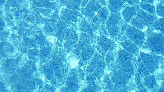 Gorgeous celeste waters in a swimming pool in summer in slow motion