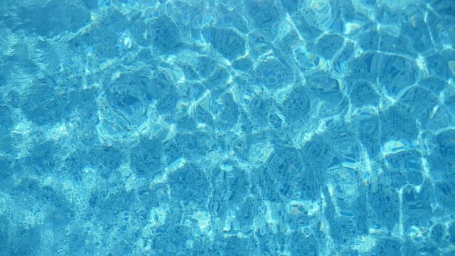 Beautiful turquoise waters in a swimming pool in summer in slow motion