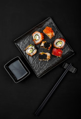 Set of sushi rolls on stone table. Top view with copy space