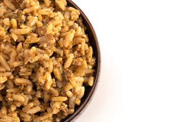 Cajun Dirty Rice in a Wooden Bowl on a White Background