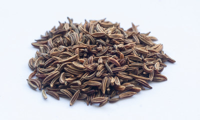 macro of Cumin seeds/Caraway seeds on a white background