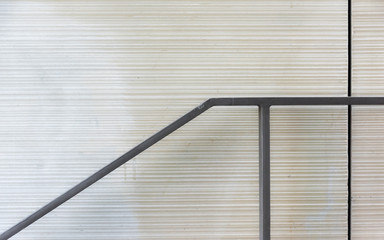 The railing and the fugue in front of a plain wall