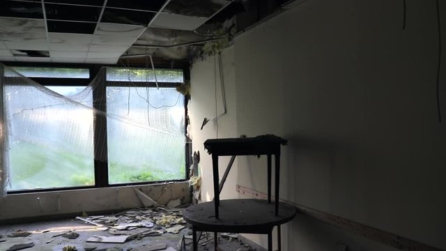 Pan Left Of Abandoned Hotel Room With Plastic On Windows. Urbex Theme.