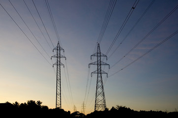 Fototapeta premium Electrical Hydro Towers and Cables at Sunset
