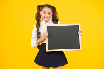 Schoolgirl pupil informing you. School girl hold blank chalkboard copy space. Announcement and promotion. Check this out. Girl school uniform hold blackboard. Back to school concept. Do not forget