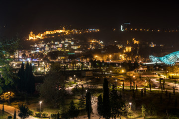 Fototapeta premium Night view of old Tbilisi. Narikala Fortress and other landmarks of the city.