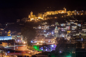 Naklejka premium Night view of old Tbilisi. Narikala Fortress and other landmarks of the city.