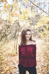 Happy girl in a top in an atumn park