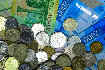 Russian banknotes and coins. A handful of coins on new Russian banknotes in denominations of 2000...