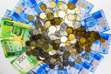 Russian banknotes and coins. A handful of coins on new Russian banknotes in denominations of 2000...