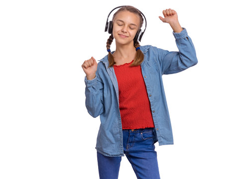 Portrait of happy teen girl with headphones, isolated on white background. Cheerful beautiful child listening to music and dances. Emotional portrait of cute caucasian teenager enjoying music.