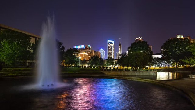 Charlotte NC Generic Urban Evening Cityscape View from a Vibrant Downtown Park Fountain with Lights Reflecting from the Water on a Colorful Night in North Carolina