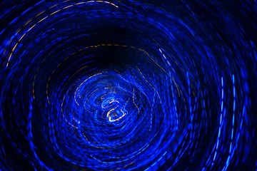 moved blue beautiful blurred bokeh background with copy space. Holiday texture. Glitter multicolored light spots on navy blue backdrop, defocused