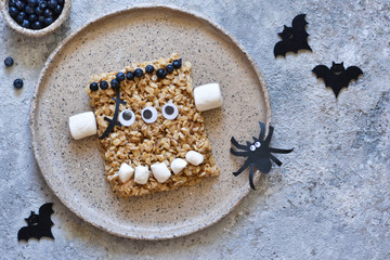 Halloween treat. A creative idea for a children's lunch is porridge, with berries and marshmallows. Funny lunch for children on Halloween.