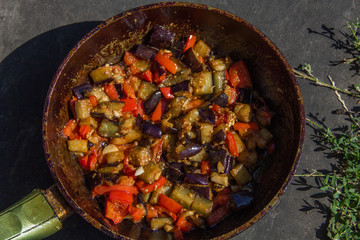 fried or fried eggplant, carrots, bell peppers, onions in a pan