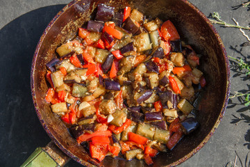 fried or fried eggplant, carrots, bell peppers, onions in a pan