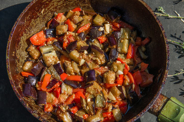 fried or fried eggplant, carrots, bell peppers, onions in a pan