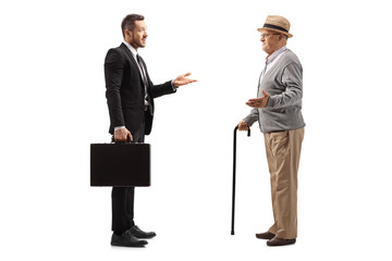 Businessman with a suitcase having a conversation with an elderly gentleman