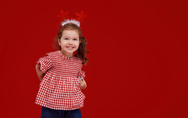 Smiling Christmas little girl isolated on red background