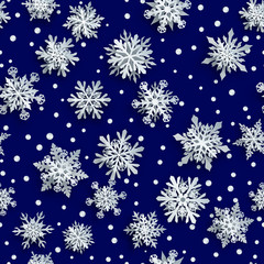 Christmas seamless pattern of white complex paper snowflakes with soft shadows on dark blue background