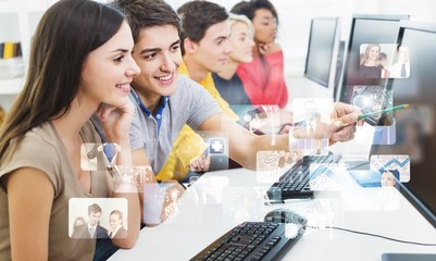Group of Students with computers at lesson in classroom