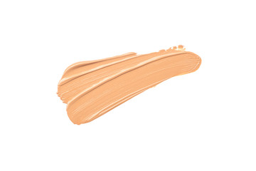 Bright beige smear of foundation in the form of a group of diagonal strokes isolated on a white background.