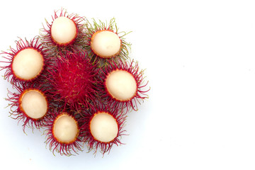Fresh Rambutan with green leaves isolated on white background