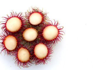 Fresh Rambutan with green leaves isolated on white background