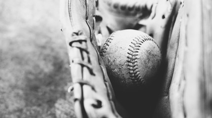 Vintage baseball in player mitt close up, black and white sports concept with copy space. © ccestep8