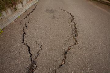 photo of gray cracked asphalt pavement