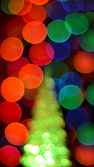 Blurred lights of christmas tree abstract bokeh soft focus background. Defocus New Year spruce with garland