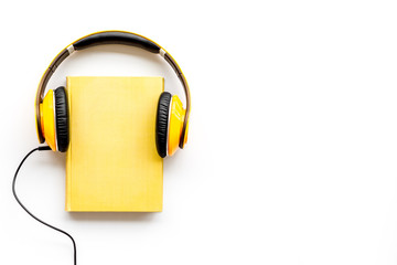listen to audio books with headphone on white background flatlay mock up