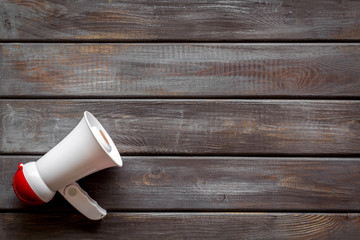 Announcement with megaphone on wooden background top view mockup