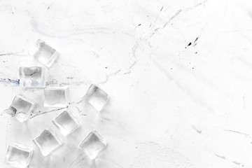 Pile of ice cubes on marble bar desk background top view mockup