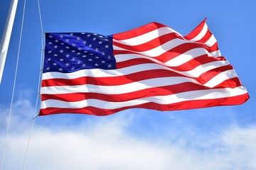 American flag flying high on a summer day