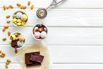 summer dessert with ice cream with hazelnut, chocolate on white wooden backgroung top view copyspace