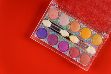 Makeup eye shadows in clear box.