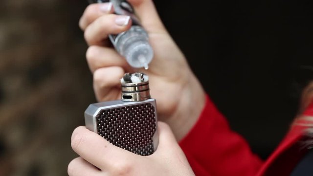 Vape Brown Tobacco Juice Tank Refill. Vaping eCigarette Tools in Background.