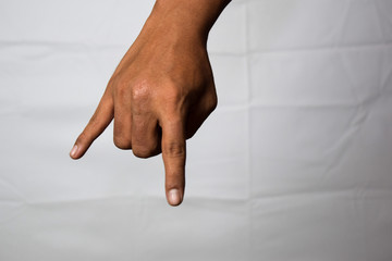 Close up Asian man shows hand gestures it means Horns isolated on white background